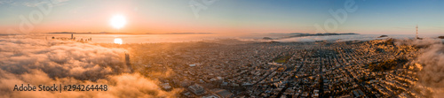 Beautiful cloudy morning in San Francisco, USA. Sunset over the clouds with skyscrapers rising through the clouds.