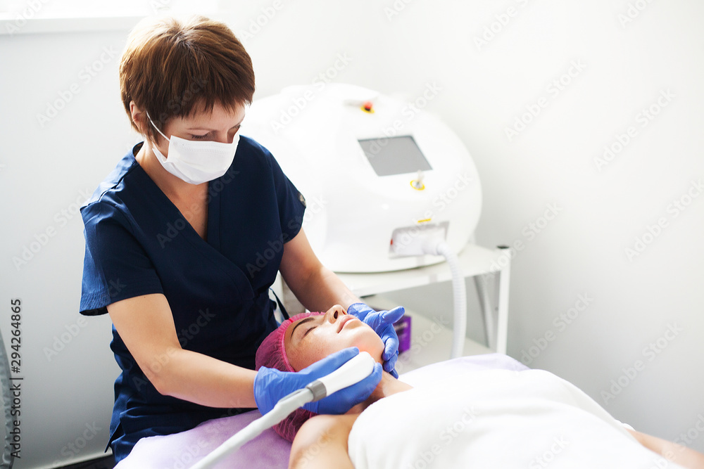 Woman getting LPG hardware massage at the beauty clinic. Professional beautician working. Woman getting LPG hardware massage at the beauty clinic. Professional beautician working.