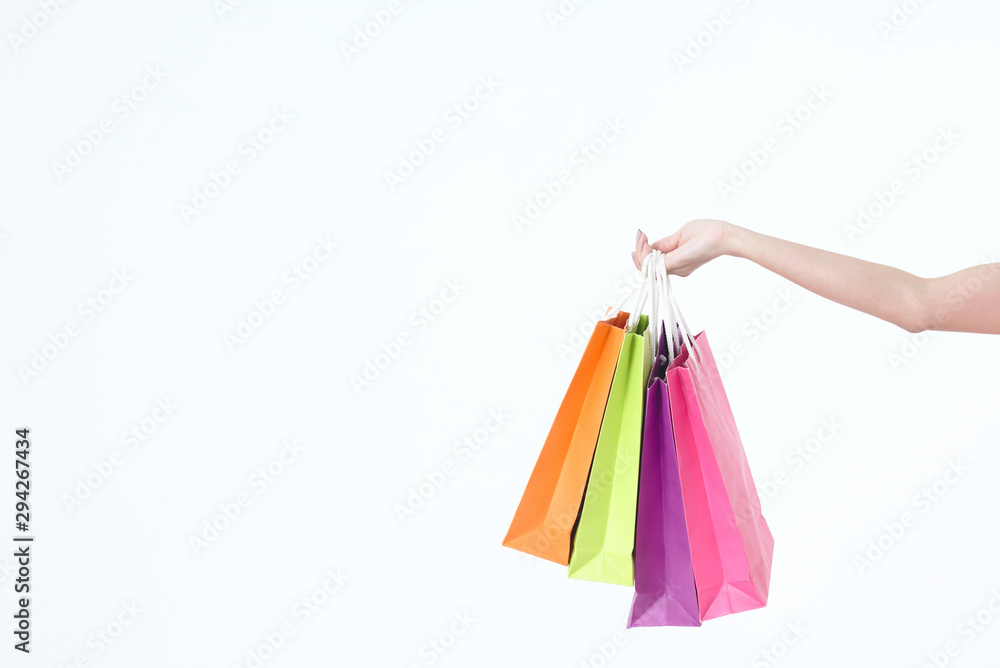 hand holding paper shopping bags isolated on white background