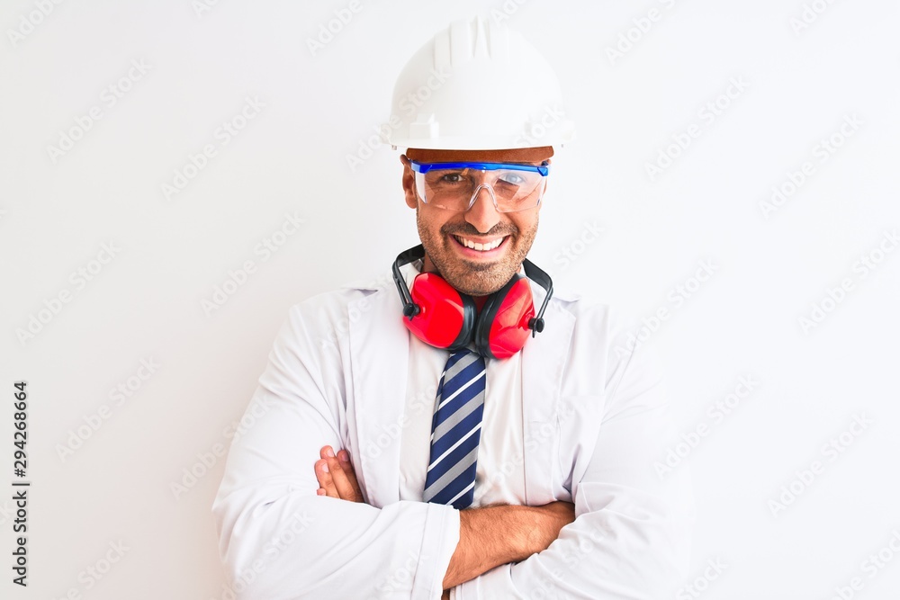 Young chemist man wearing security helmet and headphones over isolated background happy face smiling with crossed arms looking at the camera. Positive person. Young chemist man wearing security helmet and headphones over isolated background happy face smiling with crossed arms looking at the camera. Positive person.