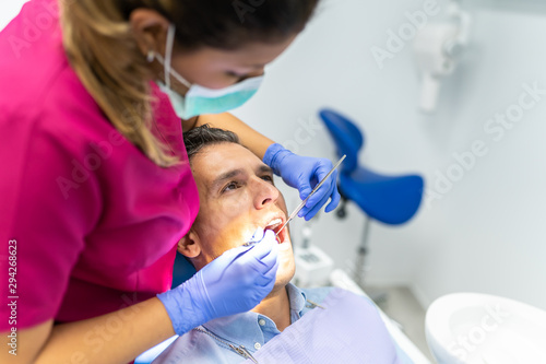 Young Dentist Woman Doing a Check Up to a Patient.