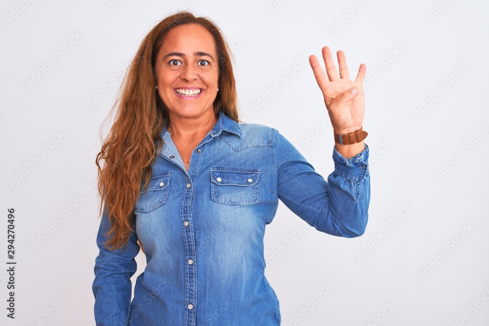 Middle age mature woman wearing denim jacket standing over white isolated background showing and pointing up with fingers number four while smiling confident and happy. Middle age mature woman wearing denim jacket standing over white isolated background showing and pointing up with fingers number four while smiling confident and happy.
