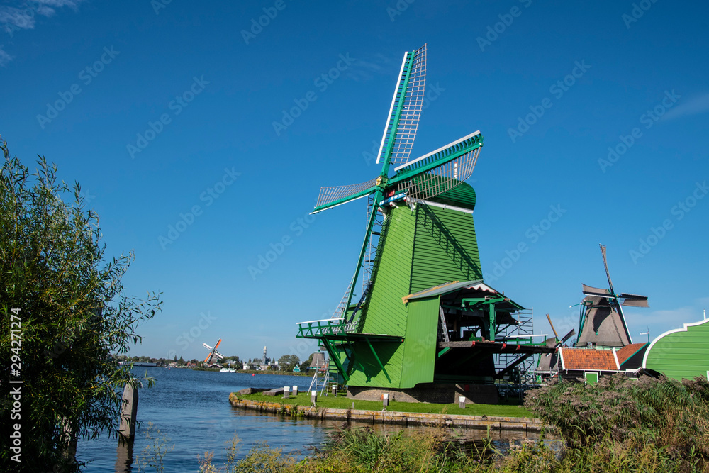 Zaanse Schans, Netherlands - 1 October 2019: Tourists sightseeng traditional Dutch rural houses in Zaanse Schans, is a typical small village within Amsterdam area.
