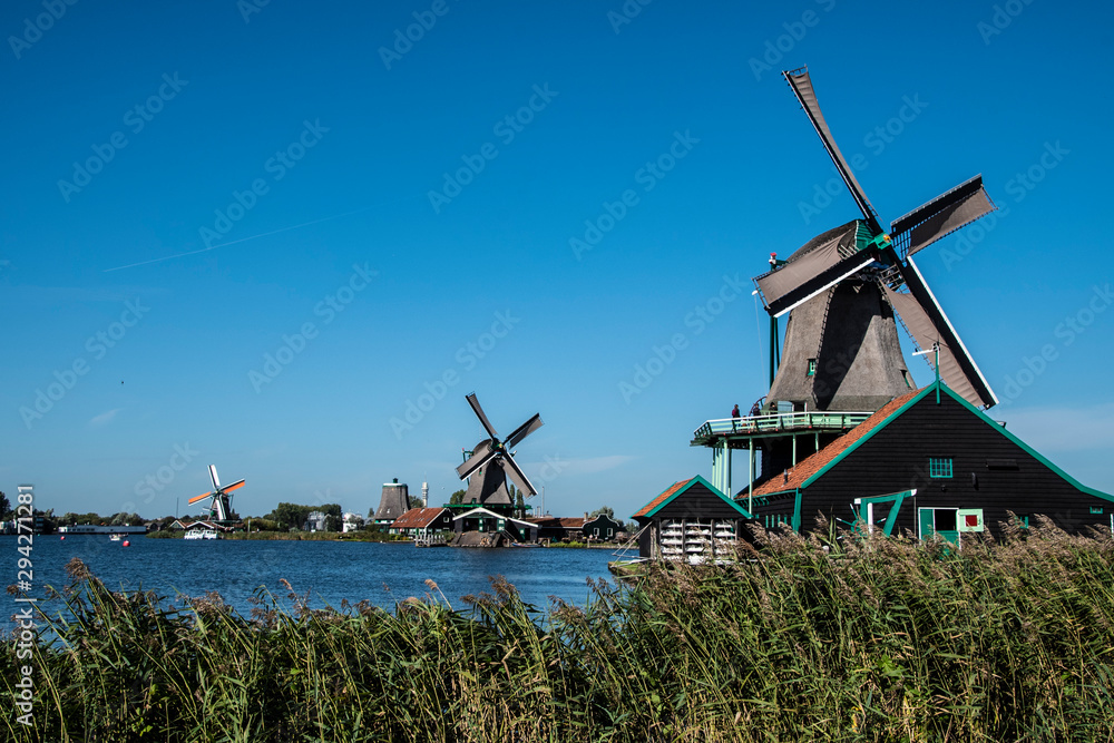 Zaanse Schans, Netherlands - 1 October 2019: Tourists sightseeng traditional Dutch rural houses in Zaanse Schans, is a typical small village within Amsterdam area.