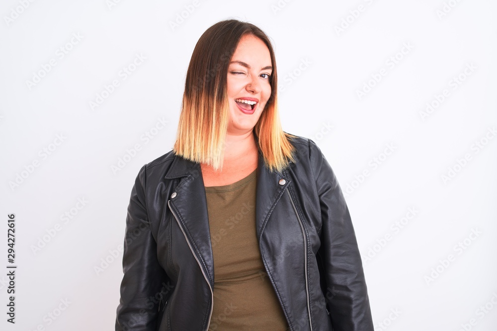 Young beautiful woman wearing t-shirt and jacket standing over isolated white background winking looking at the camera with sexy expression, cheerful and happy face. Young beautiful woman wearing t-shirt and jacket standing over isolated white background winking looking at the camera with sexy expression, cheerful and happy face.