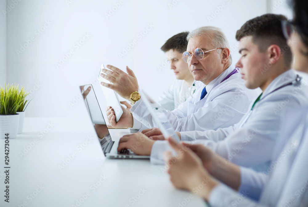 Medical team sitting and discussing at table Medical team sitting and discussing at table