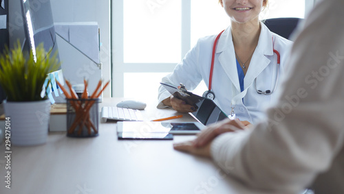 A doctor is talking and examining a patient photo