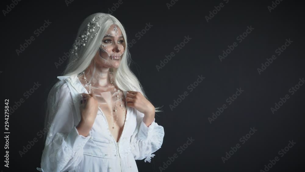 moon spirit in dark black room and turns to sun light, gray-haired attractive girl in white vintage light dress with pearl jewelry, lady came from dead, creative makeup and image for the holidays moon spirit in dark black room and turns to sun light, gray-haired attractive girl in white vintage light dress with pearl jewelry, lady came from dead, creative makeup and image for the holidays