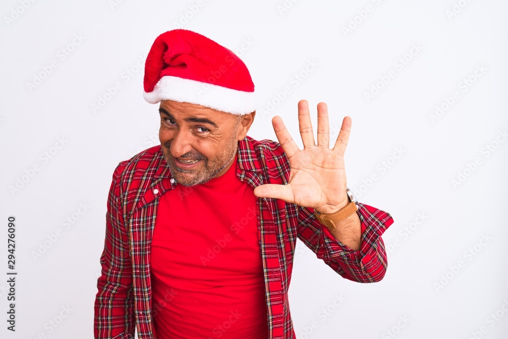 Middle age man wearing Christmas Santa hat standing over isolated white background showing and pointing up with fingers number five while smiling confident and happy. Middle age man wearing Christmas Santa hat standing over isolated white background showing and pointing up with fingers number five while smiling confident and happy.