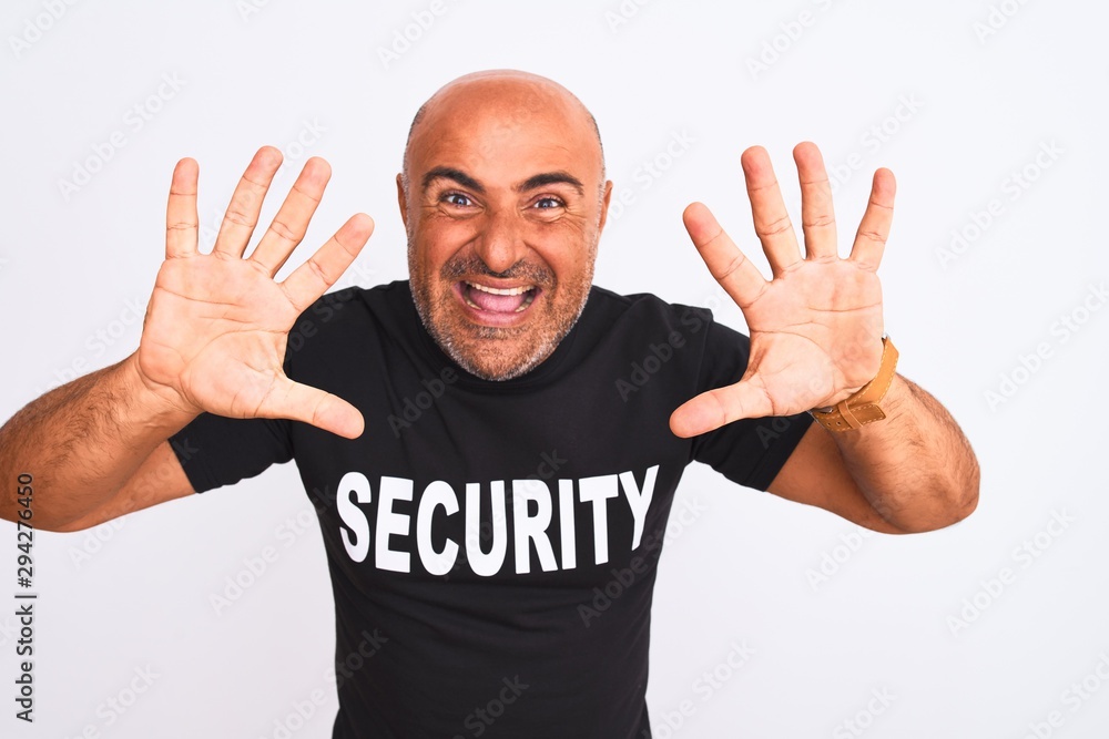 Middle age safeguard man wearing security uniform standing over isolated white background showing and pointing up with fingers number ten while smiling confident and happy.
