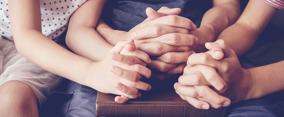 children praying with parent at home, family worship online together, home church, hope and gratitude concept