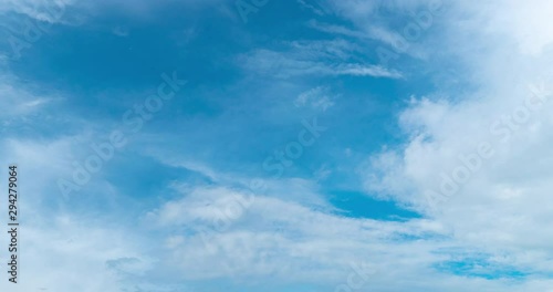 timelapse of cirrus clouds over bright blue sky moving smothly