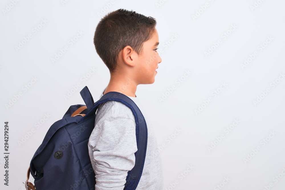 Beautiful student kid boy wearing backpack standing over isolated