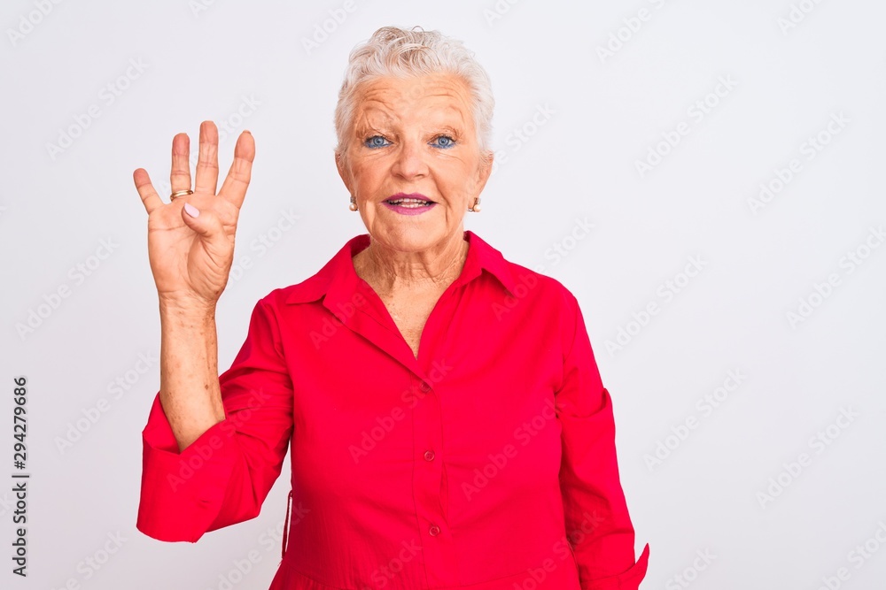 Senior grey-haired woman wearing red casual shirt standing over isolated white background showing and pointing up with fingers number four while smiling confident and happy. Senior grey-haired woman wearing red casual shirt standing over isolated white background showing and pointing up with fingers number four while smiling confident and happy.