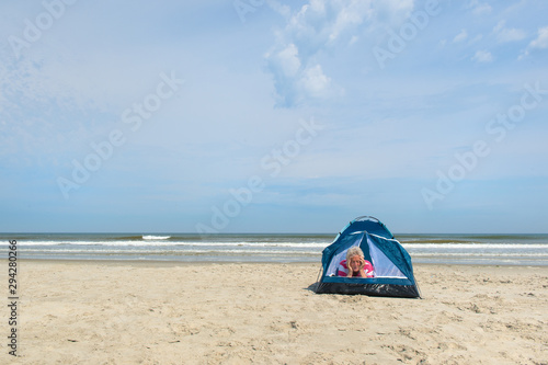 Man camping in shelter at the beach