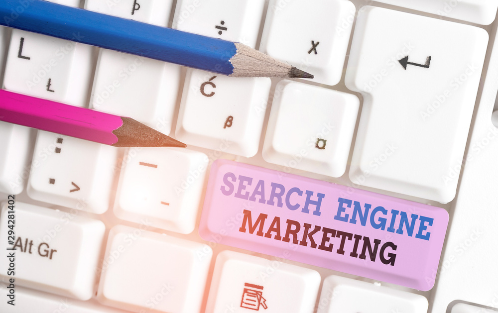 Handwriting text Search Engine Marketing. Conceptual photo promote Website visibility on searched result pages White pc keyboard with empty note paper above white background key copy space Handwriting text Search Engine Marketing. Conceptual photo promote Website visibility on searched result pages White pc keyboard with empty note paper above white background key copy space