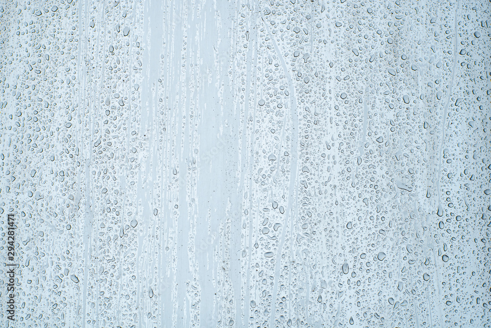 Shiny, metallic background, covered with water drops. Texture of water on a metal surface. Shiny, metallic background, covered with water drops. Texture of water on a metal surface.