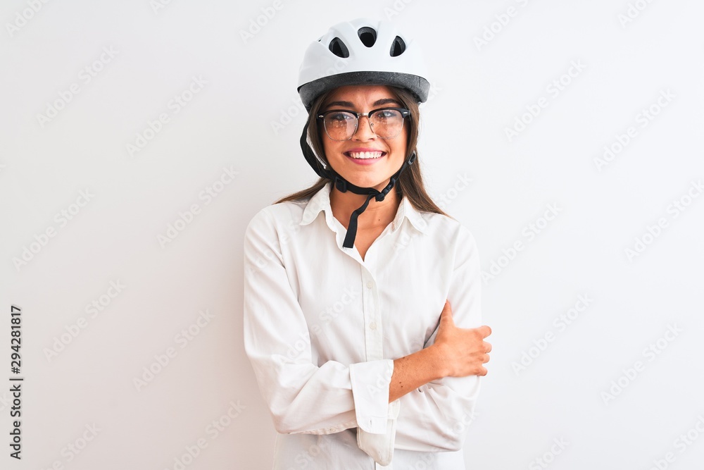 Beautiful businesswoman wearing glasses and bike helmet over isolated white background happy face smiling with crossed arms looking at the camera. Positive person. Beautiful businesswoman wearing glasses and bike helmet over isolated white background happy face smiling with crossed arms looking at the camera. Positive person.