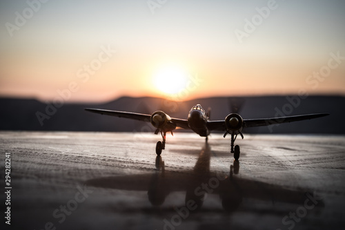 World war ii fighter plane at sunset or dark orange fire explosion sky. War scene. German figher at sky. Selective focus photo