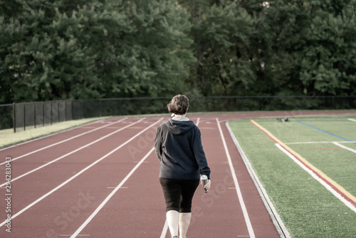 Middle age woman staying fit on track