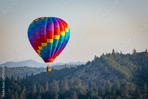 Colorful hot air balloon over Grants Pass Oregon on a beautiful summer morning