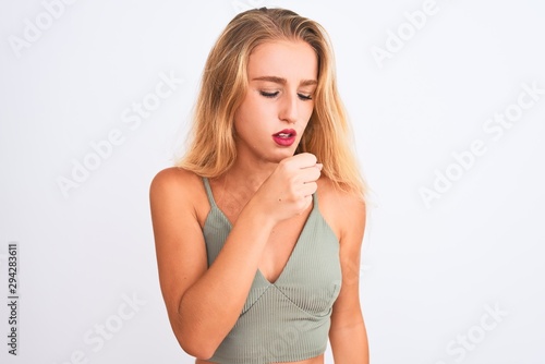 Young beautiful woman wearing casual green t-shirt standing over isolated white background feeling unwell and coughing as symptom for cold or bronchitis. Healthcare concept.
