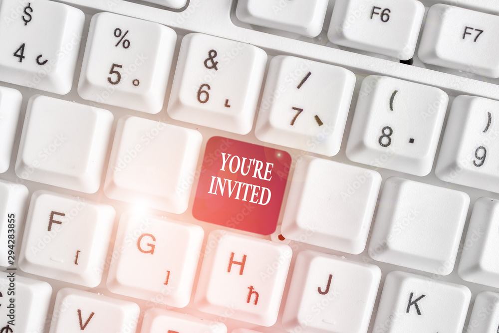 Text sign showing You Re Invited. Business photo text Please join us in our celebration Welcome Be a guest White pc keyboard with empty note paper above white background key copy space Text sign showing You Re Invited. Business photo text Please join us in our celebration Welcome Be a guest White pc keyboard with empty note paper above white background key copy space