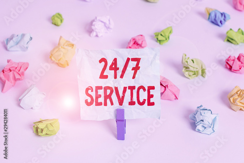 Handwriting text 24 Or 7 Service. Conceptual photo Always available to serve Runs constantly without disruption Colored crumpled papers empty reminder white floor background clothespin © Artur
