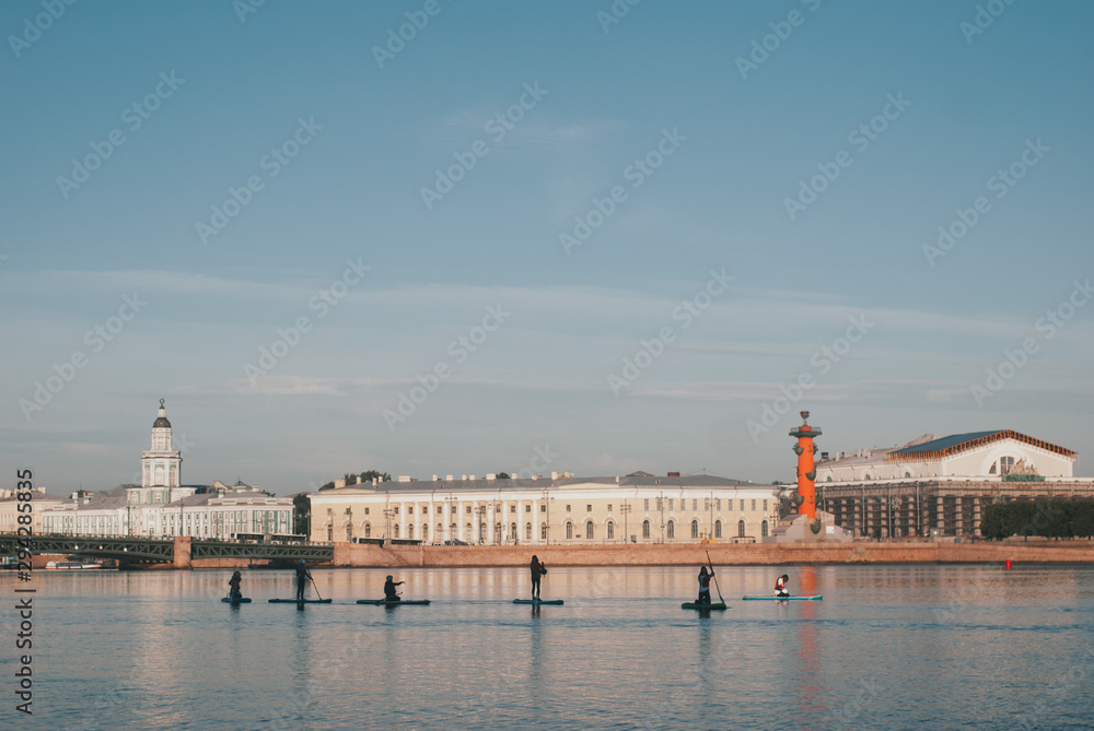 silhouettes of a surfer with a paddle in the early morning on the Neva river. paddleboarding in the Northern capital of Russia. SUP surf. St. Petersburg