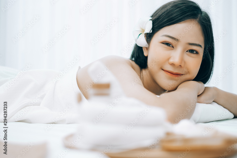 Beautiful young woman lying down on beds massage and spa at asian spa massage and beauty salon center, spa concept, massage concept Beautiful young woman lying down on beds massage and spa at asian spa massage and beauty salon center, spa concept, massage concept