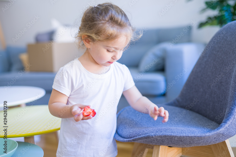 Beautiful toddler child girl eating strawberry Beautiful toddler child girl eating strawberry