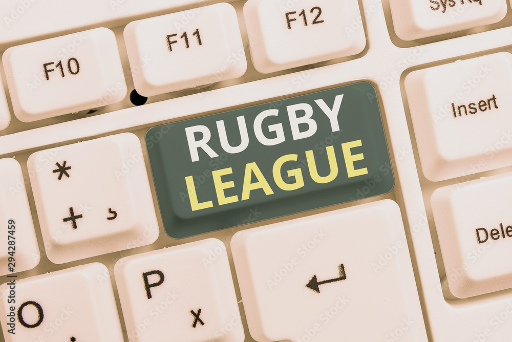 Conceptual hand writing showing Rugby League. Concept meaning form of rugby football played between teams of 13 players White pc keyboard with note paper above the white background Conceptual hand writing showing Rugby League. Concept meaning form of rugby football played between teams of 13 players White pc keyboard with note paper above the white background