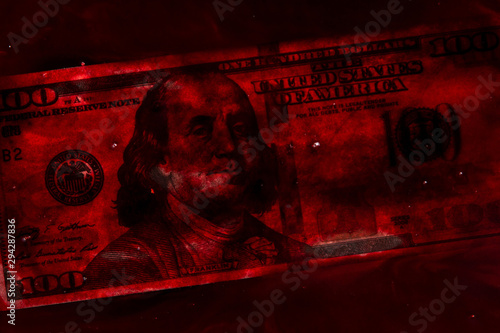 bloody business concept: 100 dollars banknote in a pool of blood