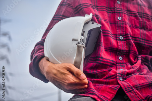 Engineer holding hardhat safety at work place background