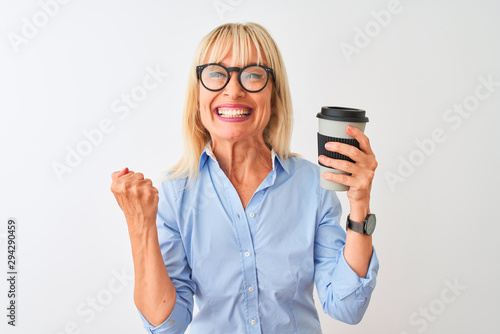 Middle age businesswoman wearing glasses drinking coffee over isolated white background screaming proud and celebrating victory and success very excited, cheering emotion