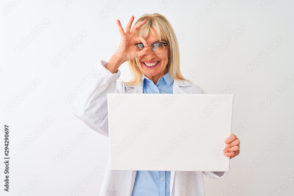 Naklejka premium Middle age scientist woman wearing glasses holding banner over isolated white background with happy face smiling doing ok sign with hand on eye looking through fingers