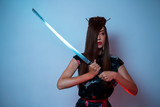 Closeup of mystic woman with samurai sword 