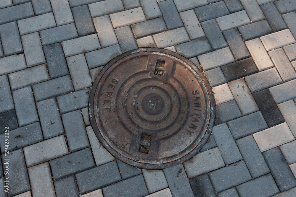Manhole Cover set in Herringbone Pattern Brick
