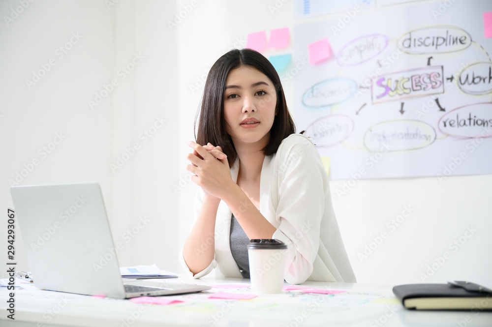 Portrait of beautiful young asian business woman working on computer laptop in office room with paperwork document on desk Portrait of beautiful young asian business woman working on computer laptop in office room with paperwork document on desk