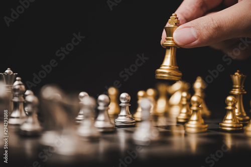 Plan leading strategy of successful business competition leader concept, Hand of player chess board game putting gold pawn