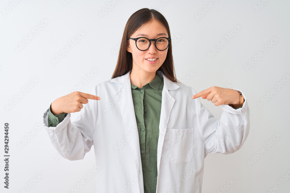 Young chinese scientist woman wearing coat and glasses over isolated white background looking confident with smile on face, pointing oneself with fingers proud and happy. Young chinese scientist woman wearing coat and glasses over isolated white background looking confident with smile on face, pointing oneself with fingers proud and happy.