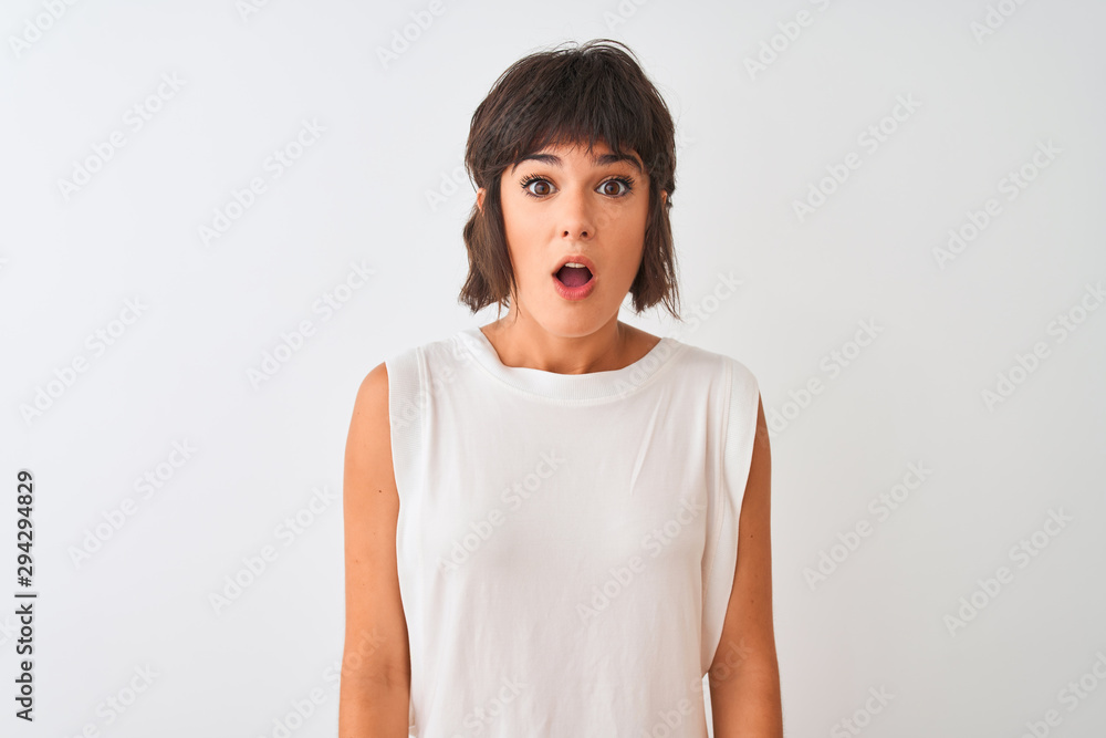 Young beautiful woman wearing casual t-shirt standing over isolated white background afraid and shocked with surprise expression, fear and excited face. Young beautiful woman wearing casual t-shirt standing over isolated white background afraid and shocked with surprise expression, fear and excited face.