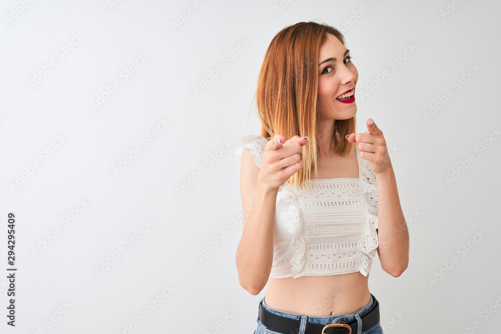 Beautiful redhead woman wearing casual t-shirt standing over isolated white background pointing fingers to camera with happy and funny face. Good energy and vibes. Beautiful redhead woman wearing casual t-shirt standing over isolated white background pointing fingers to camera with happy and funny face. Good energy and vibes.