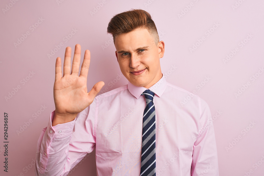 Young handsome businessman wearing shirt and tie standing over isolated pink background Waiving saying hello happy and smiling, friendly welcome gesture Young handsome businessman wearing shirt and tie standing over isolated pink background Waiving saying hello happy and smiling, friendly welcome gesture