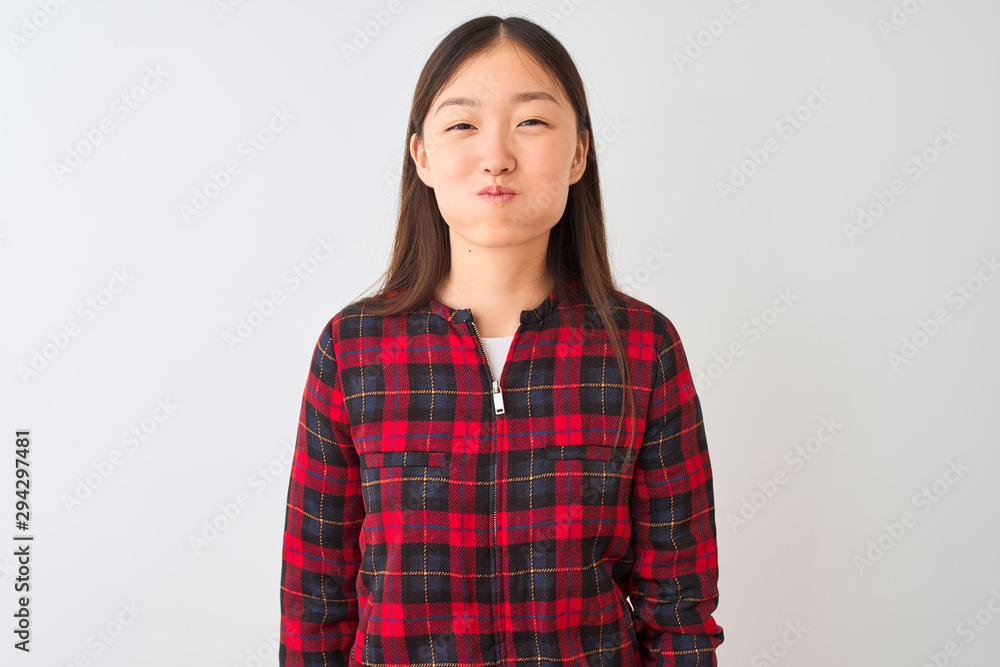 Young chinese woman wearing casual jacket standing over isolated white background puffing cheeks with funny face. Mouth inflated with air, crazy expression. Young chinese woman wearing casual jacket standing over isolated white background puffing cheeks with funny face. Mouth inflated with air, crazy expression.