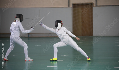 Two young women having a fencing training photo