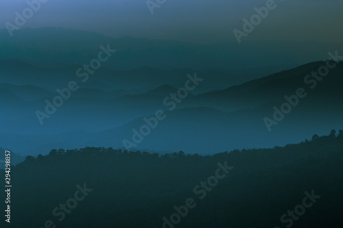 Wide natural background blurred by the bright sunlight above the mountains during the reversal of the horizon, beautiful twilight light, cold wind blowing through, fresh air