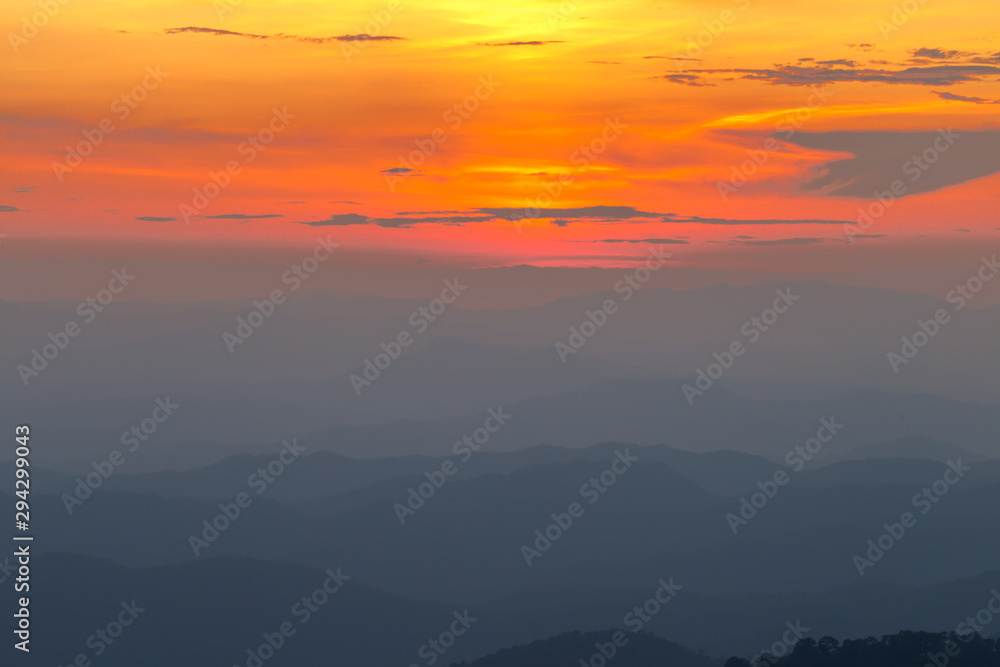 Wide natural background blurred by the bright sunlight above the mountains during the reversal of the horizon, beautiful twilight light, cold wind blowing through, fresh air