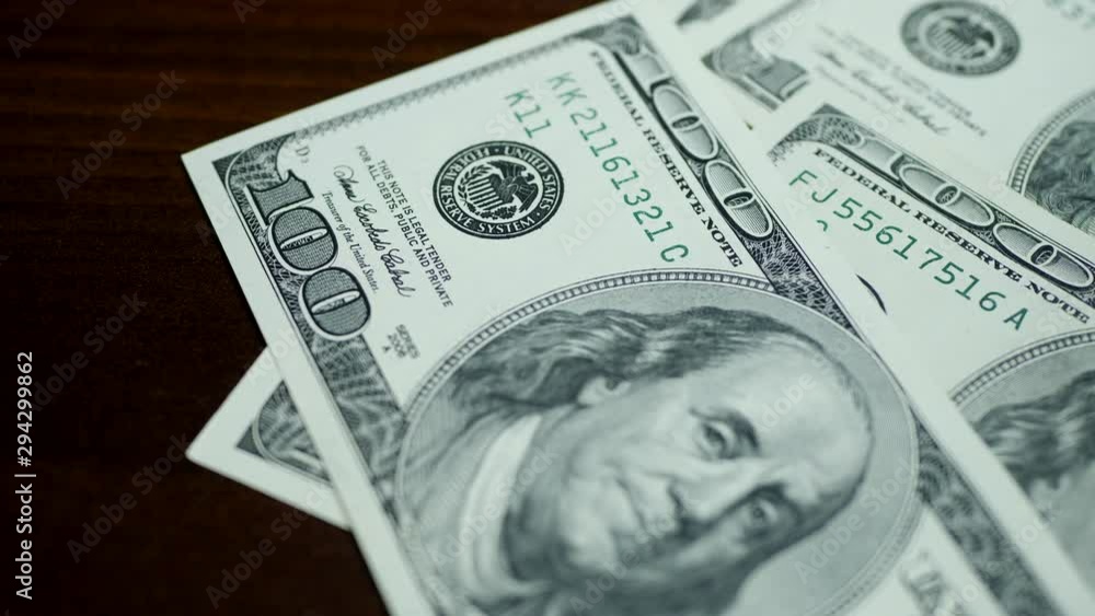 Counting 100 dollar bills on wooden table. Concept of savings, salary, payment and funds. Stack of money Counting 100 dollar bills on wooden table. Concept of savings, salary, payment and funds. Stack of money