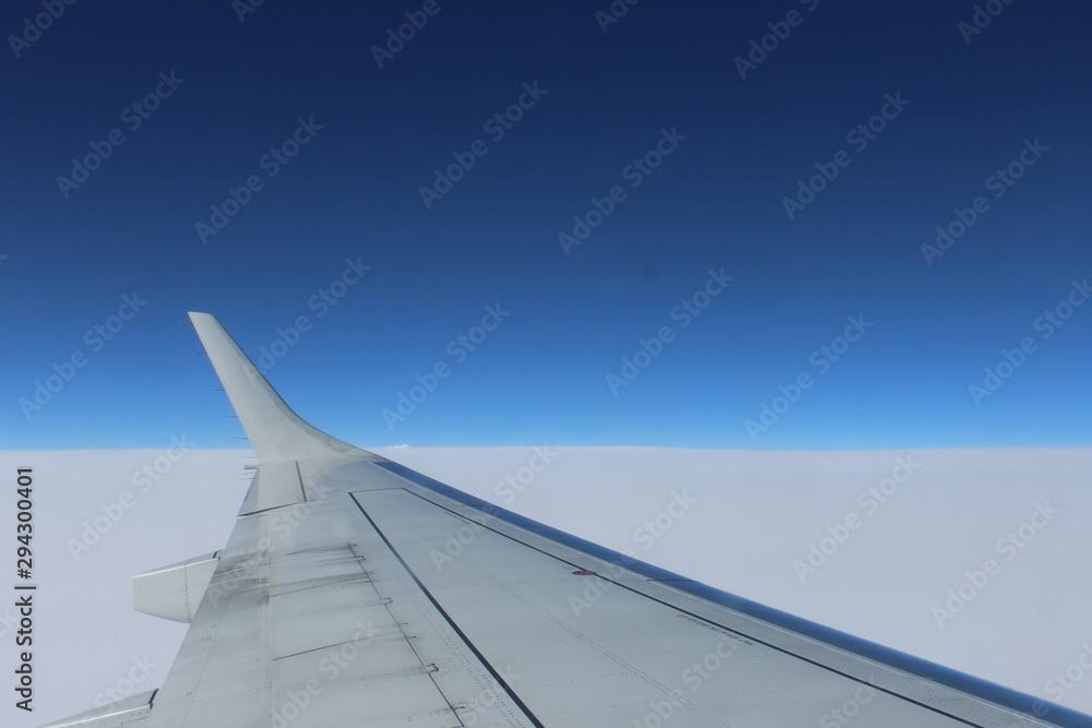Plane wing above clouds
